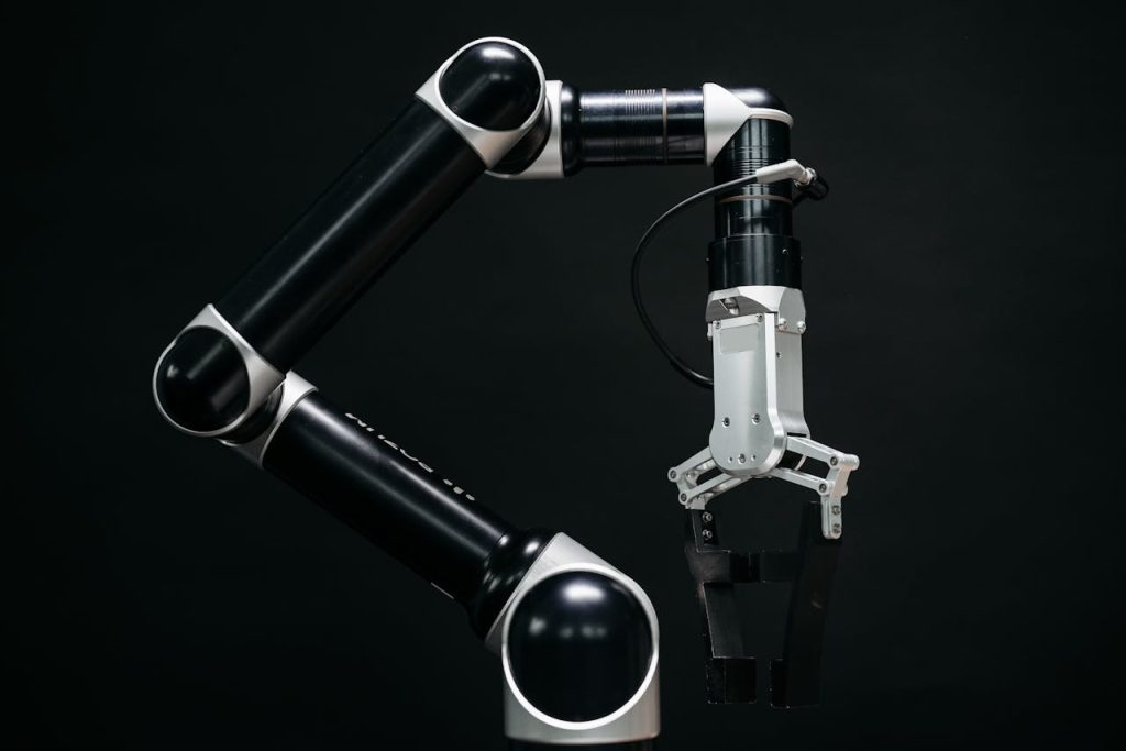 pexels-photo-8438865 Close-up of a mechanical robotic arm with a dark background, showcasing advanced technology.